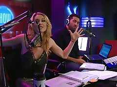 Playboy Radio's Morning Show has some of the hottest women you've ever seen! They're talking about Halloween costumes, and their guest has a cop outfit on that looks sexy as hell. It gets even sexier when her top comes off, baring her tits. The female host comes over and helps shorten the skirt.